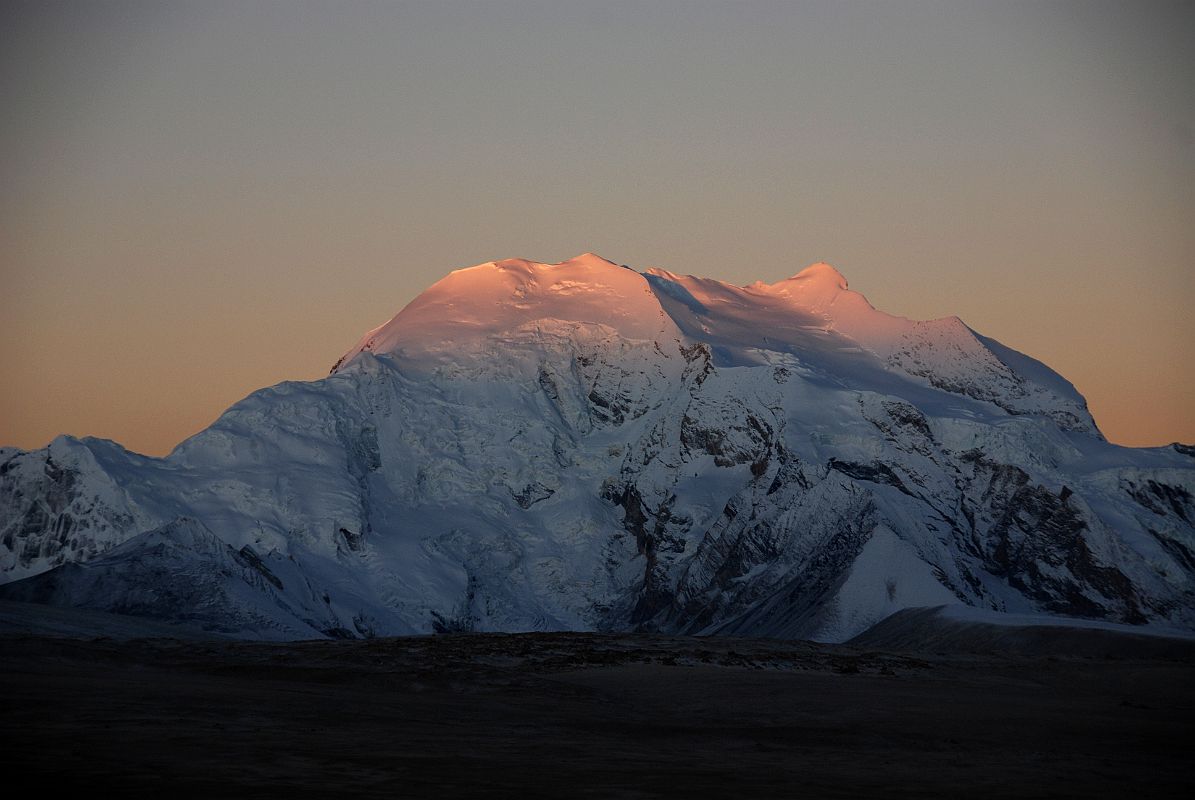 11 Sunrise Starts On Gang Benchen From Shishapangma North Base Camp The first rays of sunrise slowly shine on Gang Benchen from Shishapangma North Chinese Base Camp.